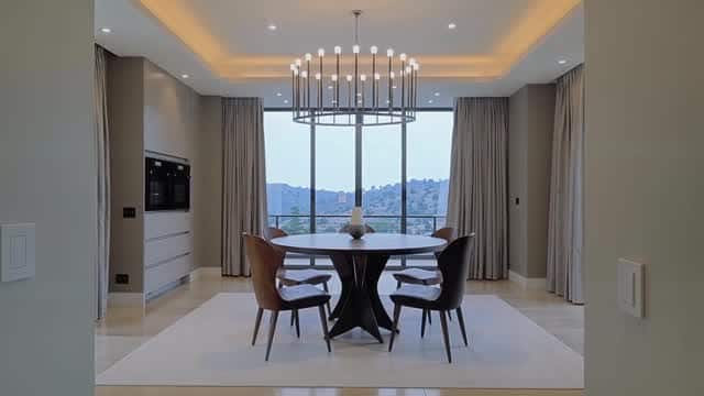 Modern luxury dining room overlooking a scenic landscape AI video preview