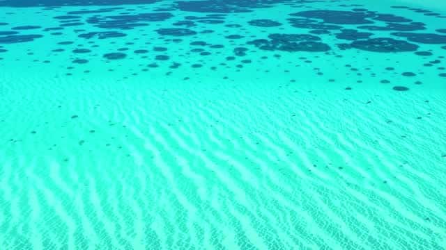 Clear turquoise ocean ripples on the sandy seafloor AI video preview