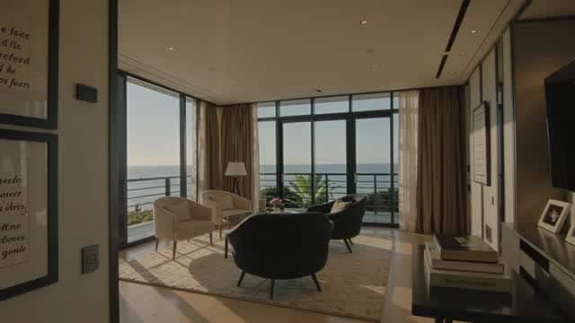 Luxurious indoor lounge overlooking tropical ocean view AI video preview