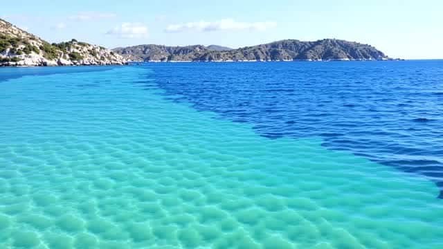 Scenic tropical coastline with deep blue ocean and turquoise lagoon AI video preview