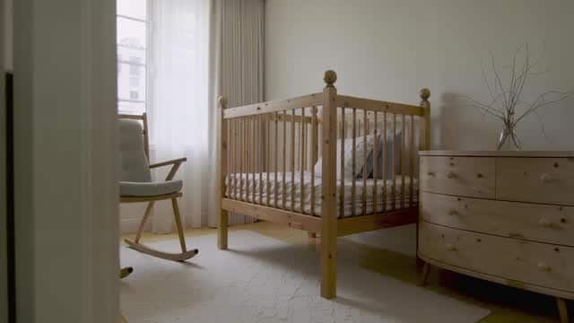 Bright minimalist baby nursery room decor featuring wooden furniture AI video preview