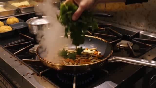 Cooking herbs and ingredients in a professional kitchen AI video preview