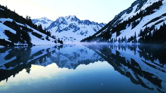 Serene view of alpine mountain lake reflection in winter AI video preview