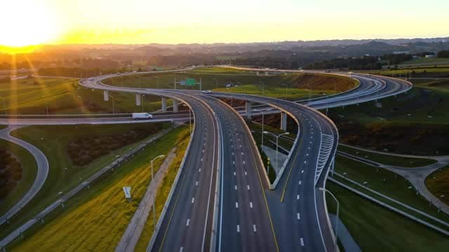Sunrise aerial view of modern multi lane highway interchange AI video preview